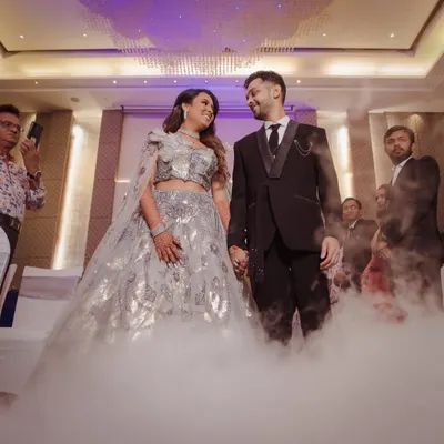 A fairytale moment for the couple during their reception. We used a low-lying fog effect to create this dreamy, 'dancing on clouds' look for their entrance.