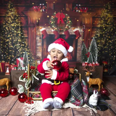 Here's a cute little Santa to wish you a Merry Christmas! This baby is dressed in a full Santa suit, surrounded by festive decorations.