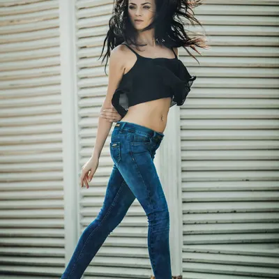 Capturing motion and energy for a denim brand shoot. The wind-blown hair and dynamic stride create a feeling of freedom and confidence, perfectly matching the casual vibe of the jeans and top.