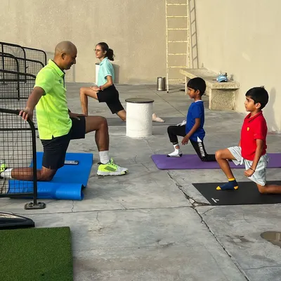 Our tournaments are designed as learning experiences. Here, junior players go through a structured warm-up routine before their round.