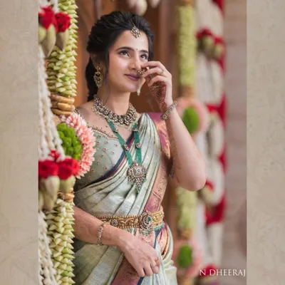 Our client Ranjitha, the epitome of grace in a pastel Kanjivaram tissue saree. The soft finish and subtle sheen of the fabric make it a perfect choice for elegant daytime events.