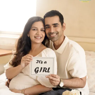 A joyful announcement from the comfort of their home. Using simple props like this "It's a Girl" sign, we capture the excitement of the big reveal in a personal and intimate setting.