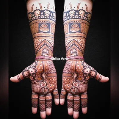 A full bridal arm design with incredible detail, featuring domes, peacocks, and intricate filler patterns.