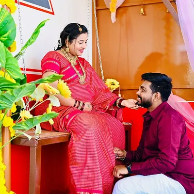 A beautiful moment of connection in my Halli Mane set. The vibrant colors of the traditional attire stand out against the red and white walls, creating a culturally rich maternity portrait.