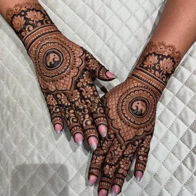 A beautiful full-hand design with a central elephant mandala. The surrounding pattern is a mix of fine lines and bold floral work.