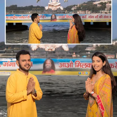 With the magnificent Shiva statue in the background, the couple offers a prayer with folded hands. This shot beautifully merges their spiritual journey with their journey as a couple, captured at the Ganga.
