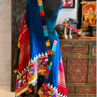 This chadar is a confluence of tribal weaves, blending hand-spun organic Kala cotton from Gujarat with vibrant Kutchi embroidery. It also incorporates a treasured hemp weave from Laos and Saput Poleng cotton from Bali.
