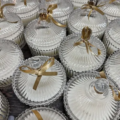 These elegant crystal jars filled with scented soy wax are a timeless choice for wedding favors. The intricate glass design catches the light beautifully, and the gold ribbon adds a touch of celebration.