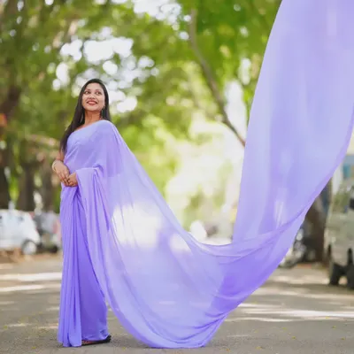 This lavender trail saree is captured in motion, with its long, lightweight pallu flying gracefully in the air. It's a beautiful way to add drama to a traditional outfit.