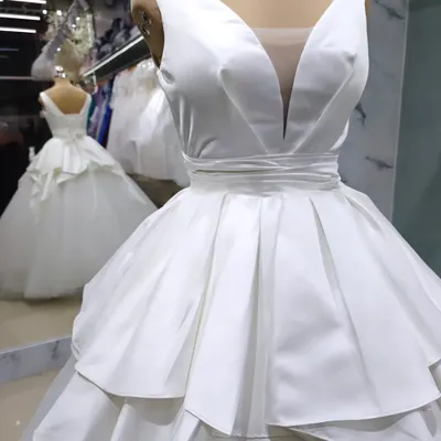 This modern satin bridal gown is one of my favorite creations. The deep V-neckline and structured, architectural peplum create a powerful and sophisticated silhouette for the contemporary bride.