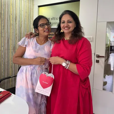 A happy moment in the clinic, personally handing over a Valentine's Day giveaway hamper to a wonderful client.