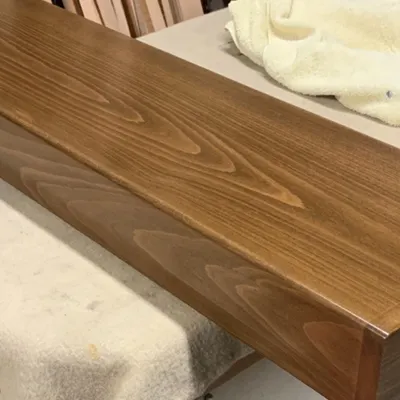 This is a solid wood tread for a centre spine staircase, finished to a high standard. Crafting architectural elements like this requires precision and a deep understanding of the material.