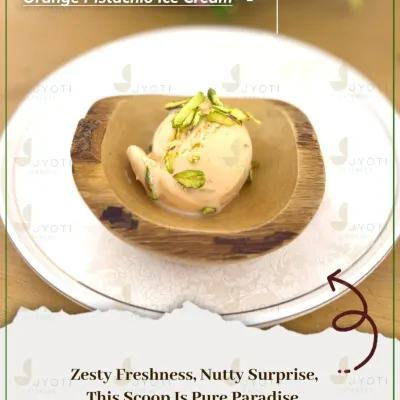 A scoop of pure paradise. This Orange Pistachio Ice Cream combines zesty freshness with a nutty surprise, served in a beautiful wooden bowl.