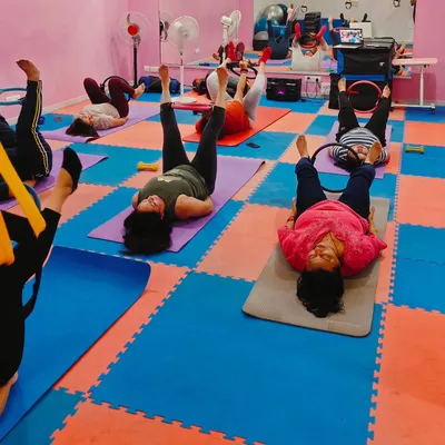 A mat Pilates session in progress. The cushioned floor mats provide comfort and support for floor-based exercises.