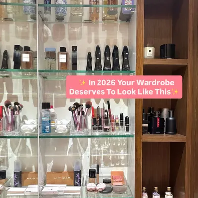 Your vanity area should inspire you every morning. We organized this client's collection of perfumes, makeup, and brushes on clear glass shelves with integrated lighting, creating a clean and glamorous beauty station.