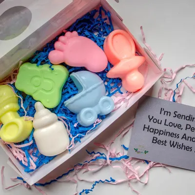 This baby shower themed soap set is a perfect return favor. It includes soaps shaped like a baby foot, rattle, pacifier, and stroller, all handcrafted with shea butter and essential oils to be completely safe for delicate skin.