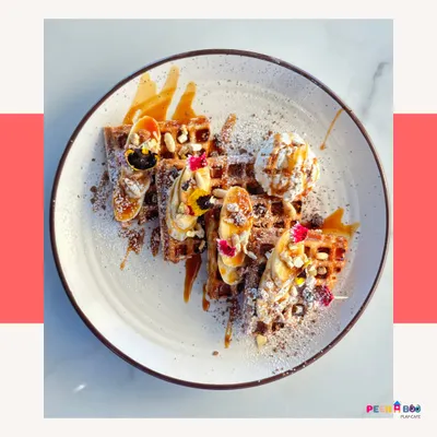 Feast your eyes on these gorgeous waffles, loaded with bananas, nuts, and a caramel drizzle. A perfect treat after a session of play.
