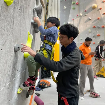 A father and son get ready for their first climb together. Our instructors are always on hand to provide one on one guidance and ensure everyone feels comfortable and ready for their climbing session.