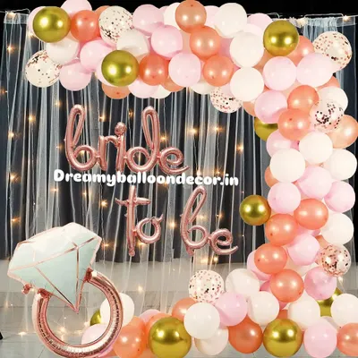 This is my popular rose gold 'Bride to be' package. It includes a beautiful balloon arch with white, pink, and confetti balloons, a large diamond ring prop, and a fairy light curtain for a perfect photo backdrop.