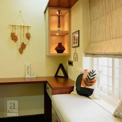 A close-up of a cozy window seat nook, featuring custom-fitted Roman blinds that offer a clean, tailored look while providing excellent light control.