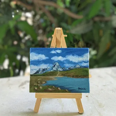 Here is the Chandrataal Lake painting resting on its mini easel. It shows how these tiny artworks can sit on your desk or a shelf, bringing a view of the Himalayas right into your room.