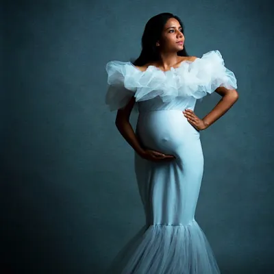 In the studio, we can sculpt with light to create dramatic and timeless fine art portraits. The focus is completely on the mother-to-be, highlighting her strength and beauty in a classic setting.