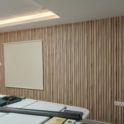 An off-white roller blind installed in an office. This provides a simple, non-distracting window covering solution that is perfect for a professional environment.