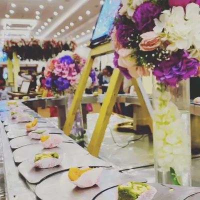 A close-up of our innovative conveyor belt, serving beautifully crafted desserts. This feature adds a dynamic and modern element to the dining experience.