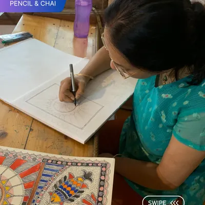 A student is deeply focused on the precise line work of her Madhubani drawing. Our studio provides the quiet intensity needed for such detailed work.
