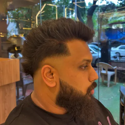 A modern men's haircut featuring a sharp fade and a styled mullet. This look is all about texture and confidence.