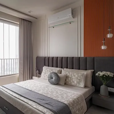 A master bedroom that makes a statement. We used color blocking with charcoal grey and a burnt orange fluted panel to create a look that is both bold and balanced, energetic and sophisticated.