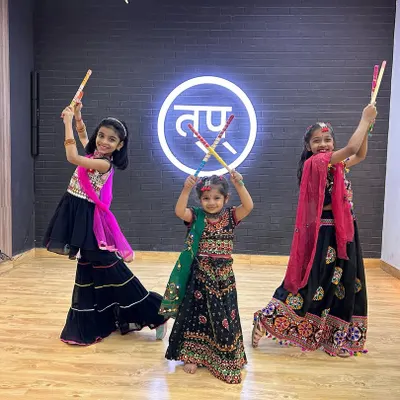 The vibrant energy of our kids' Garba class. Dressed in traditional attire and holding dandiya sticks, they are all set for a Navratri celebration.