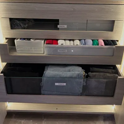 This is the power of a well-planned drawer system. With clear labels for "Pants," "T-shirts," and "Inners," everything has a logical home. The glass fronts provide a quick visual cue, making finding what you need effortless.