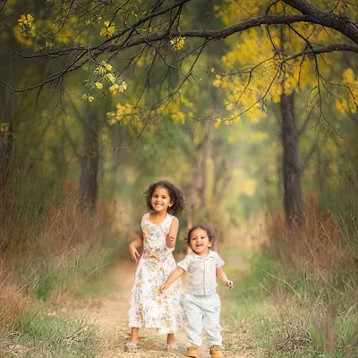 We didn't just pick a location; we chose a moment. This path in the woods was the perfect setting to capture the story of these siblings running toward their next adventure.