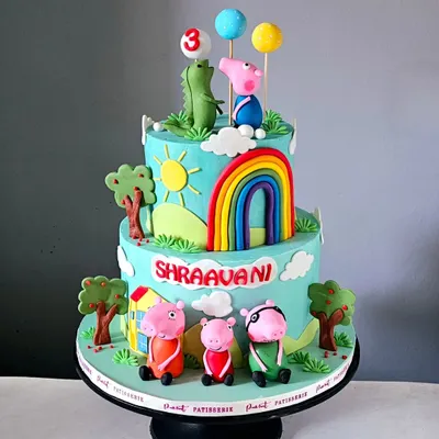 A cake that brings Peppa’s world to life! This two-tier creation features the whole Peppa Pig family, a rainbow, and Mr. Dinosaur, all handcrafted from fondant for a vibrant and playful birthday scene.