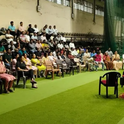 A coach addresses a large gathering of parents at our academy. These meetings are essential for communicating our rules, regulations, and the philosophy behind our training program.