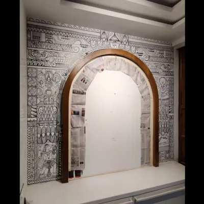 The completed puja room arch, a space transformed by intricate hand-drawn motifs. This was a meditative piece to create.