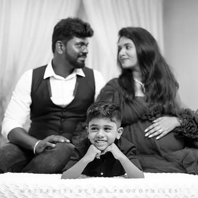 A beautiful black and white family portrait where the focus is on the older brother's joyful smile. We love capturing the excitement of the entire family.