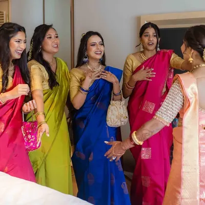The priceless reaction of the bridesmaids seeing the bride in her wedding dress for the first time. A moment of awe and happiness.