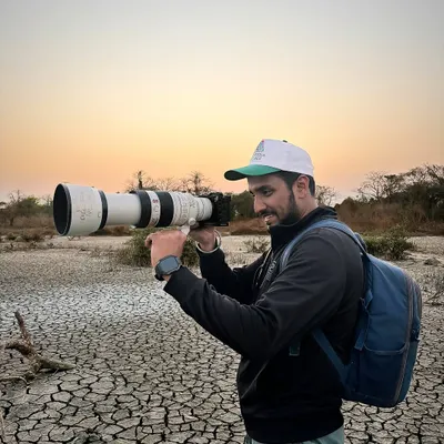 Out in the field with my telephoto lens. This behind the scenes photo shows me on location, ready to capture wildlife, showcasing the passion for photography that I bring to every project.