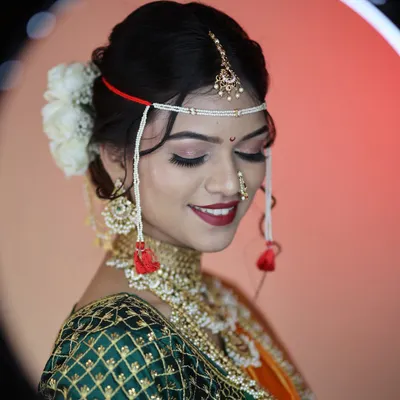 A perfect Maharashtrian bride. This look features a classic red lip, soft shimmery eyes, and the traditional 'mundavalya'. You will learn to create this timeless look in my course.