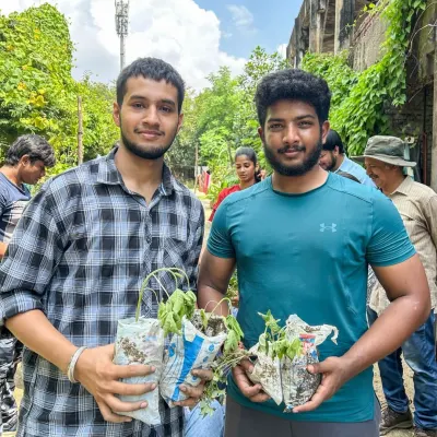 Students from Amity University holding saplings, ready to get their hands dirty. Engaging with young adults is crucial for building long-term environmental awareness and action.