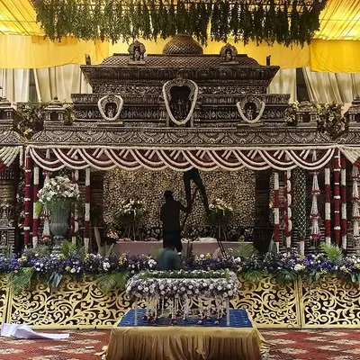 A masterpiece of traditional craftsmanship. This temple-style mandap is being prepared by our team, showcasing the intricate details and dedication that go into creating a truly divine setting for a wedding ceremony.