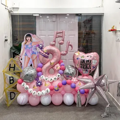 For a true Swiftie's 8th birthday, we designed this Taylor Swift 'Eras' theme. It features a life-size character cutout, musical note balloons, a disco ball accent, and personalized 'HBD' blocks for a complete pop-star party scene.