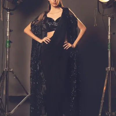 Elegance meets tradition with a modern twist. A model poses in a stunning black cape saree, a highlight from one of my recent collections.