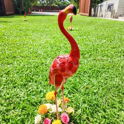 Quirky details like this pink flamingo prop add a fun and memorable touch to a vibrant outdoor Haldi or Mehendi celebration.