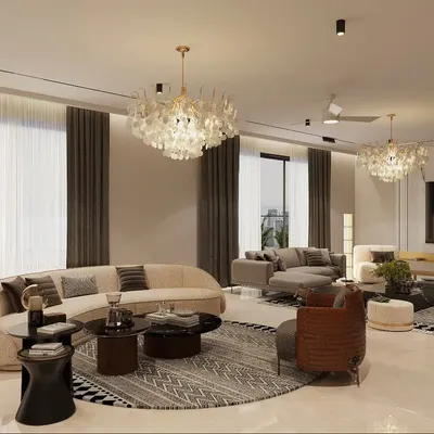 This expansive living room is designed with multiple seating zones to accommodate both large gatherings and intimate conversations. The curved sofa and shell chandeliers add a soft, organic touch to the modern space, while large windows ensure ample natural light.