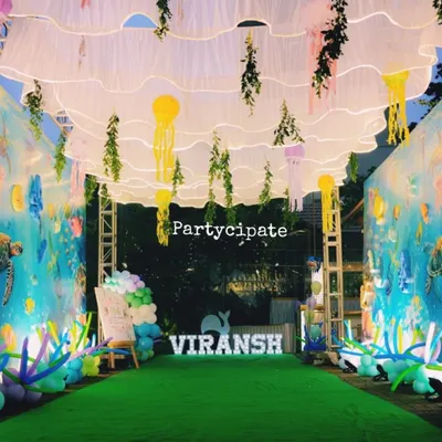 I transformed this walkway into an underwater tunnel for Viransh's first birthday. The walls were covered in a sea-life print, and I hung fabric waves and jellyfish from the ceiling to make guests feel like they were walking on the ocean floor.