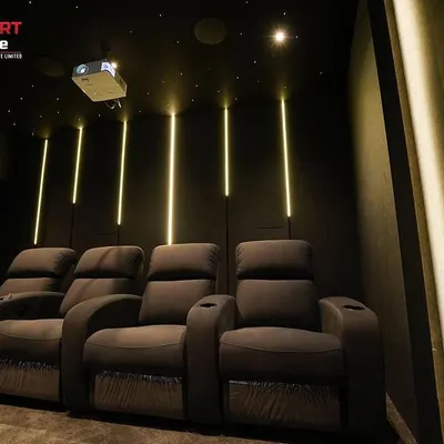 The vertical LED lighting in this Chennai cinema creates a dramatic and futuristic effect, perfectly complementing the dark, modern design.