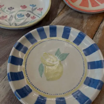 Look at these beautifully painted and glazed plates. These were all created by participants in one of our plate painting workshops. The final results are always so impressive and full of personality.